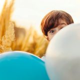 woman hiding on balloon